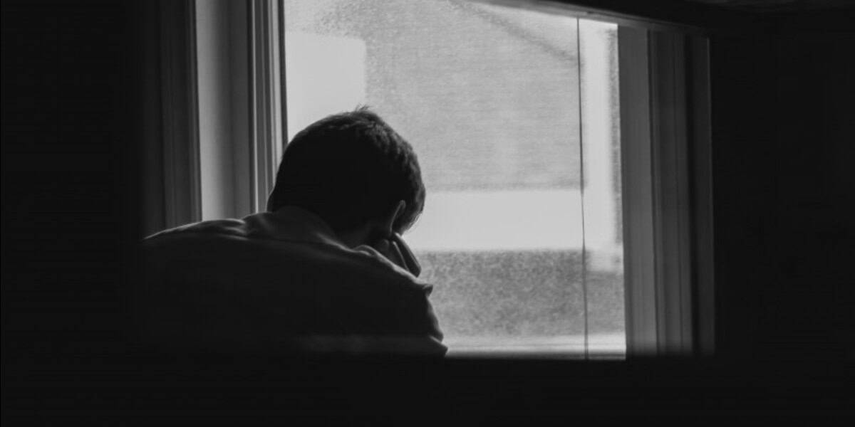 vulnerable adult sitting by window