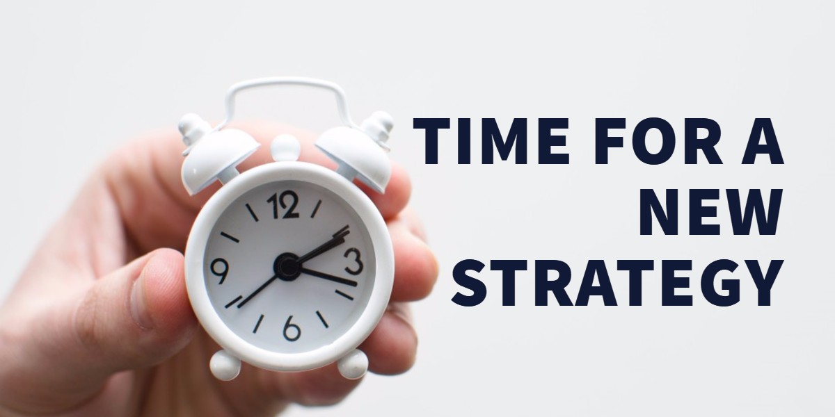 small clock with caption "time for a new strategy"